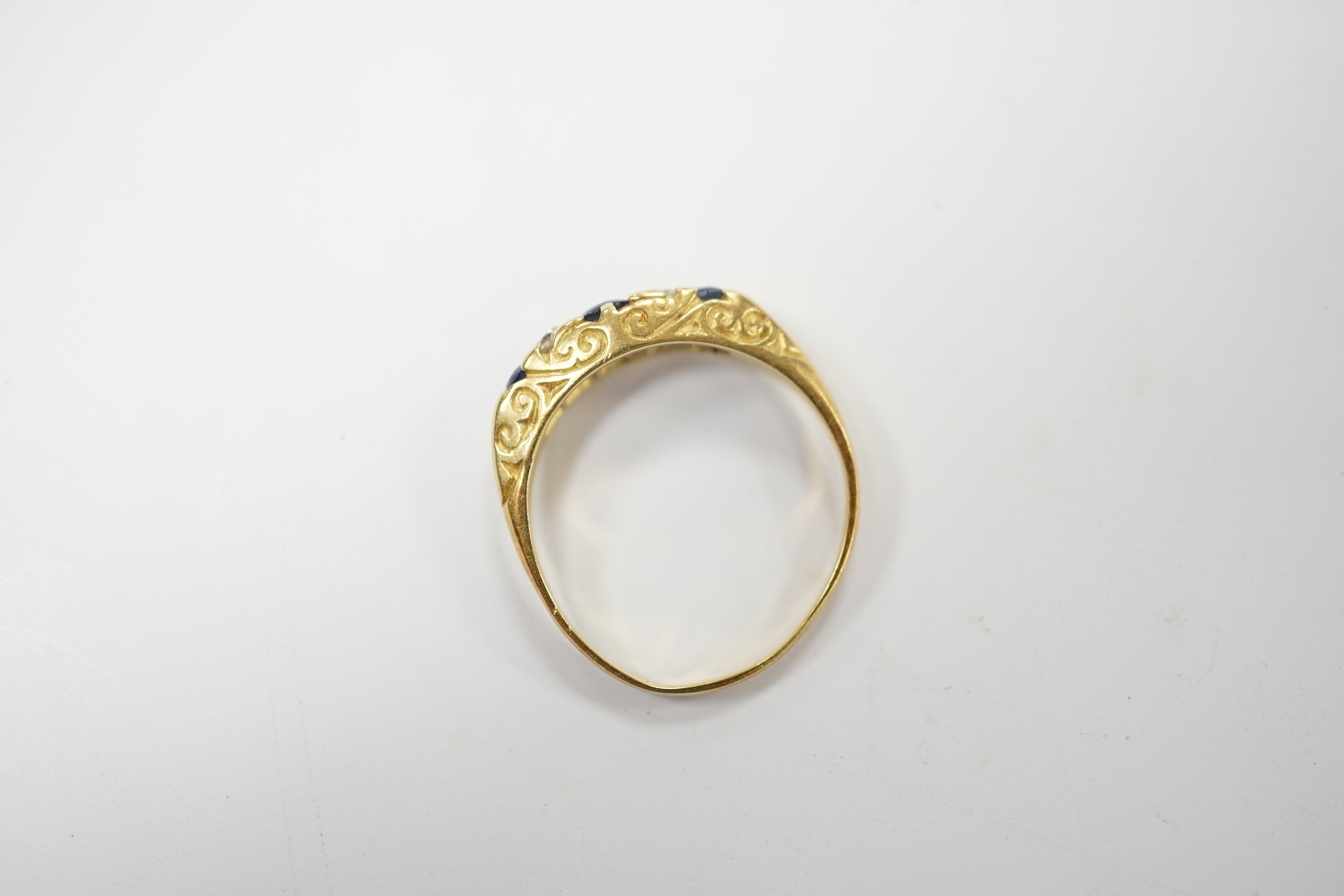 An 18ct three stone sapphire and two stone diamond set half hoop ring, size N, gross weight 3 grams. Poor condition.